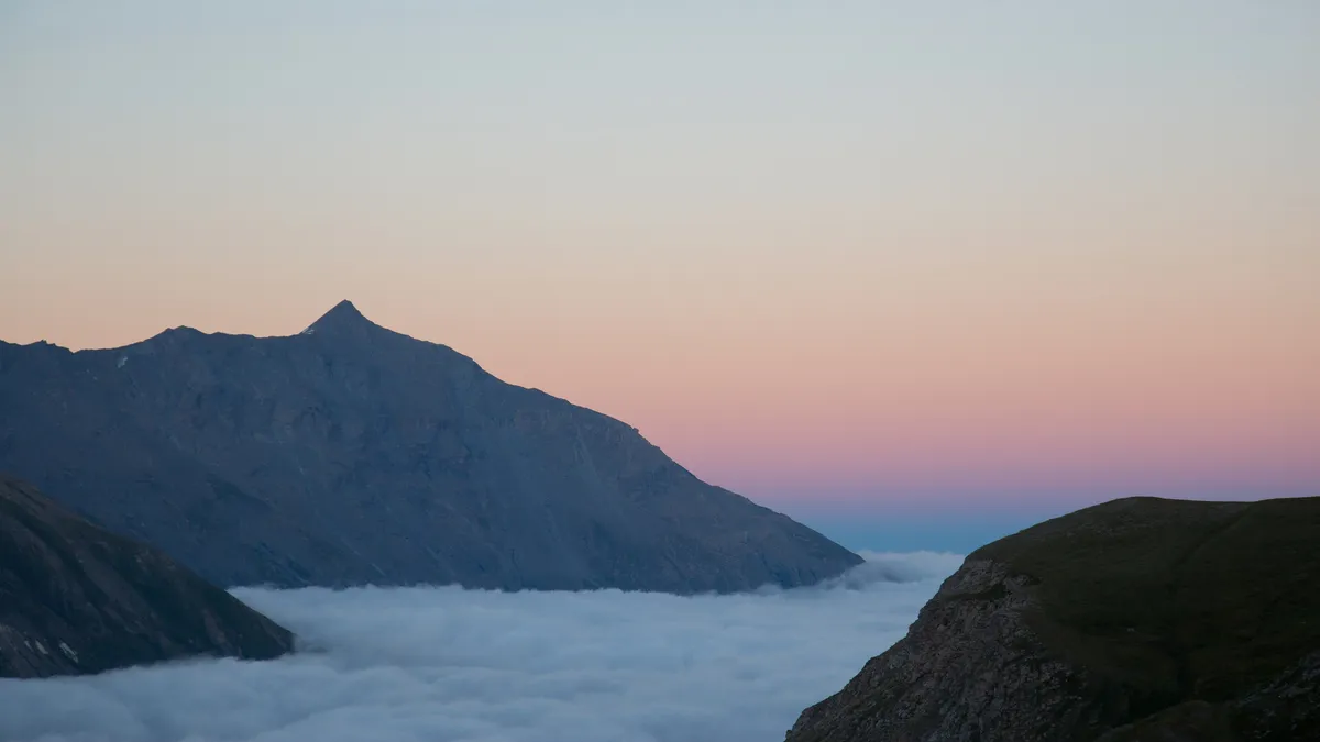 Pink dusk over a sea of clouds — Nicolas Marincic