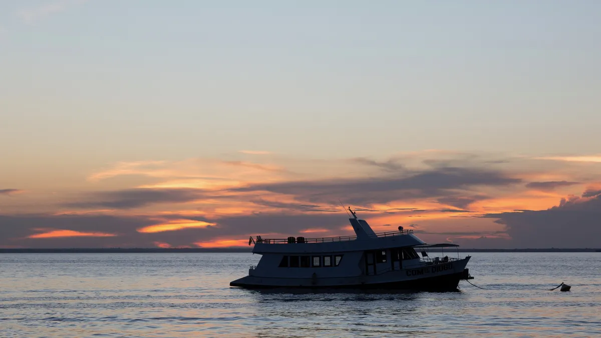 Boat silhouette at sunset, Santarém, Brazil — Nicolas Marincic