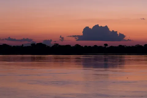 Glowing sunset cloud over the Solimões, Brazil — Nicolas Marincic