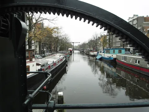 Canal framed by drawbridge gear, Netherlands — Nicolas Marincic