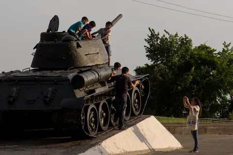 Children climbing on an old tank, Armenia — Nicolas Marincic