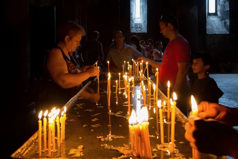 Worshippers lighting candles, Armenia — Nicolas Marincic