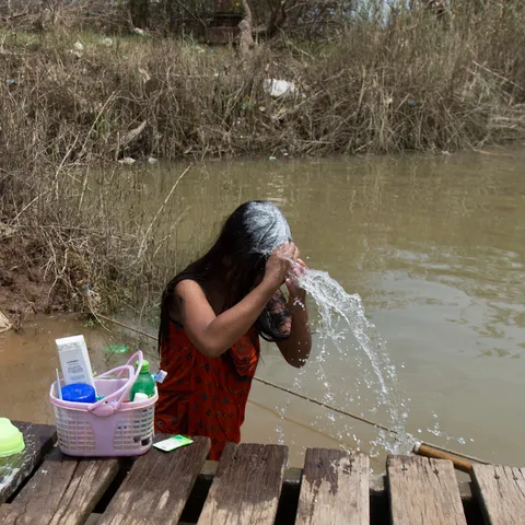 Woman washing her hair by the river, Inwa, Burma — Nicolas Marincic