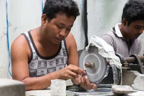 Men polishing jade at the jade market, Mandalay, Burma — Nicolas Marincic