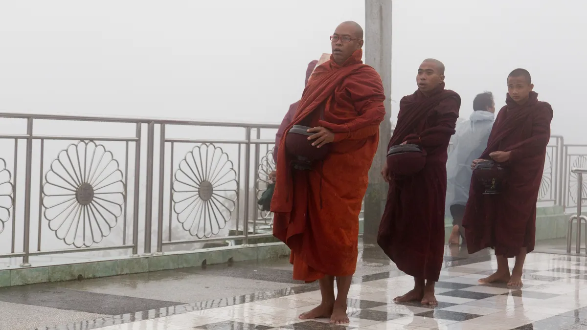 Robed monks in the rain, Burma — Nicolas Marincic