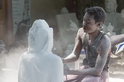 Carver polishing a marble Buddha, Burma — Nicolas Marincic