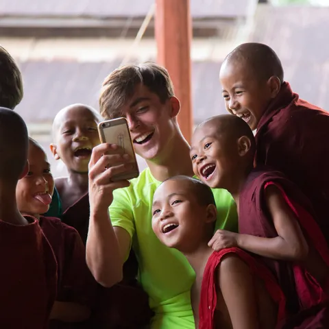 Novices laughing at a phone screen, Burma — Nicolas Marincic