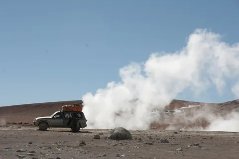 4x4 beside steaming geysers, Bolivia — Nicolas Marincic