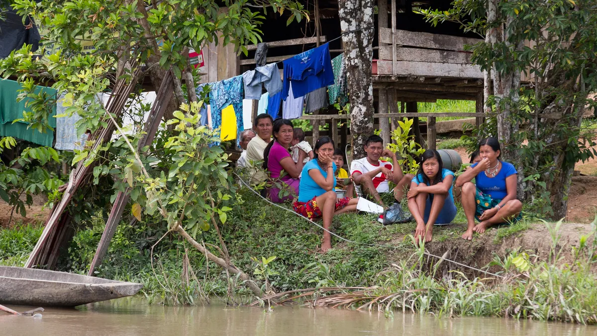 Family on the riverbank, Brazil — Nicolas Marincic