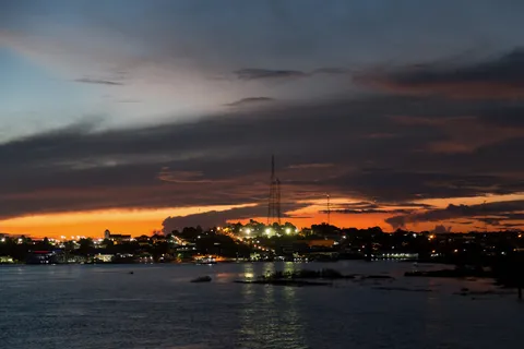 City lights at dusk across the river, Brazil — Nicolas Marincic
