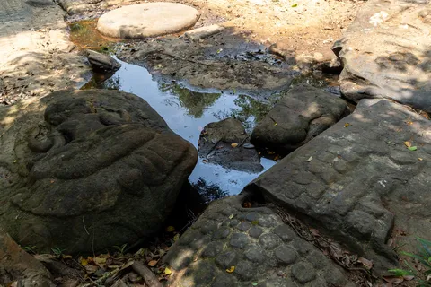 Lingas carved in the river at Kbal Spean, Cambodia — Nicolas Marincic