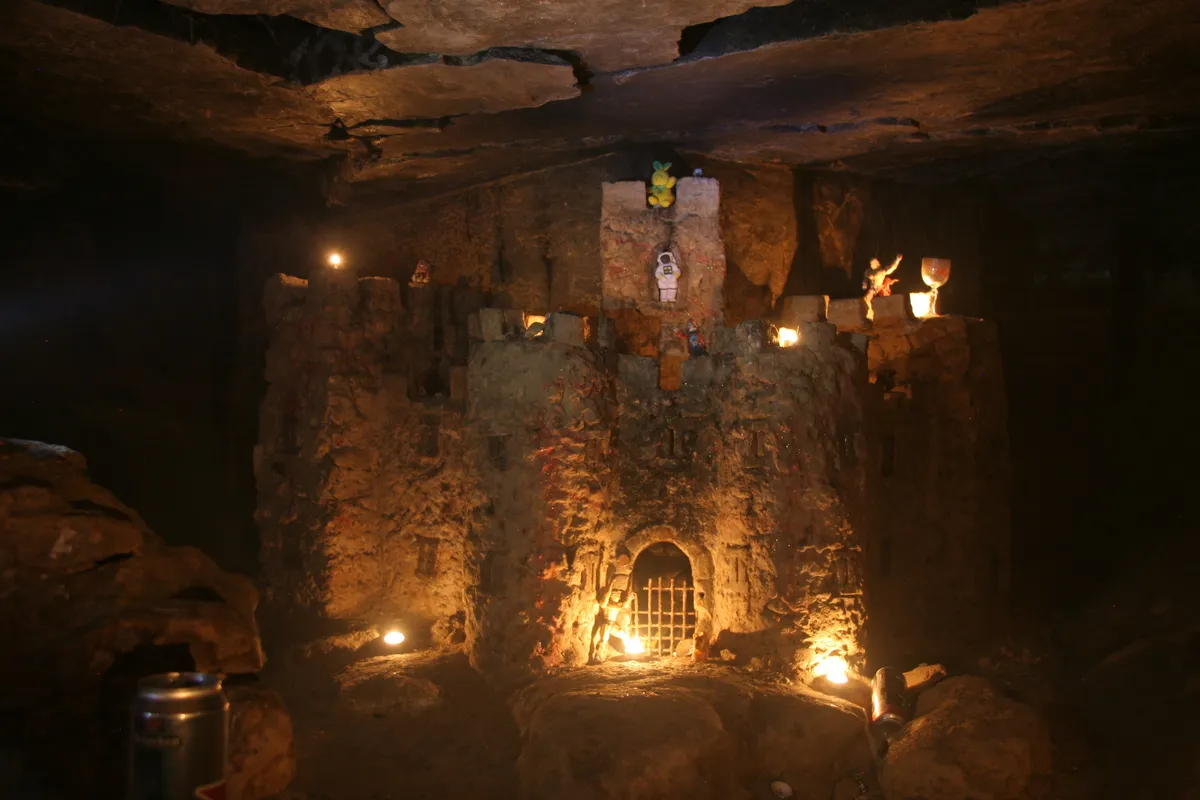 Carved castle by candlelight in the catacombs, France — Nicolas Marincic