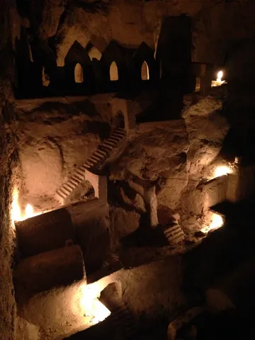 Candlelit carved village in the catacombs, France — Nicolas Marincic