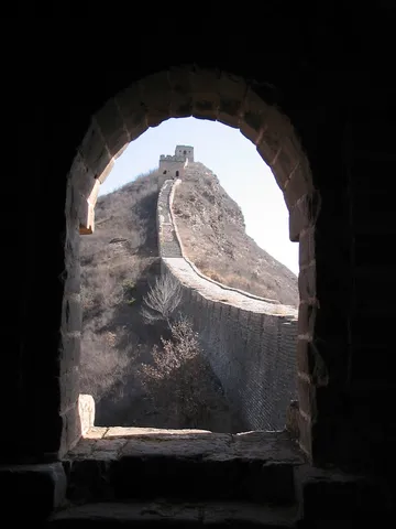 The wall framed by a watchtower arch, China — Nicolas Marincic
