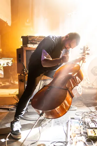 Bruit ≤ cellist over his instrument in golden smoke, France — Nicolas Marincic