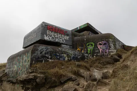 Bunker tagged “Resist” in the dunes, Opal Coast, France — Nicolas Marincic