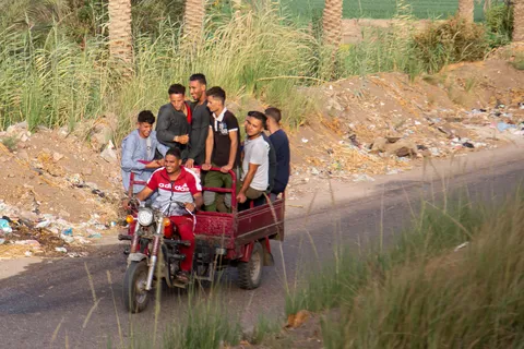 Children on a motorbike in a Middle Egypt village, Egypt — Nicolas Marincic