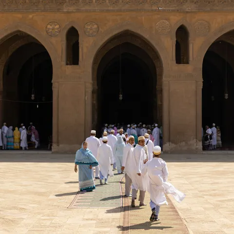 Pilgrims dressed in white beneath the arcades, Egypt — Nicolas Marincic