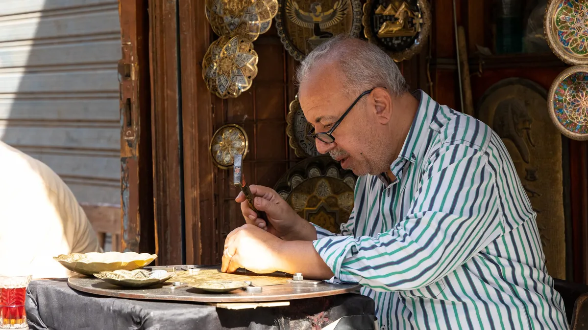 Craftsman engraving a copper tray, Egypt — Nicolas Marincic