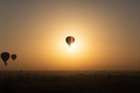 Hot-air balloon against the rising sun, Egypt — Nicolas Marincic