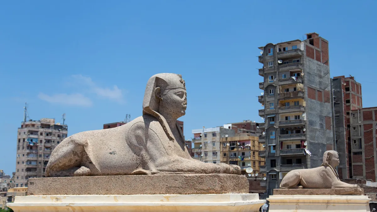 Ancient sphinx before apartment blocks, Egypt — Nicolas Marincic