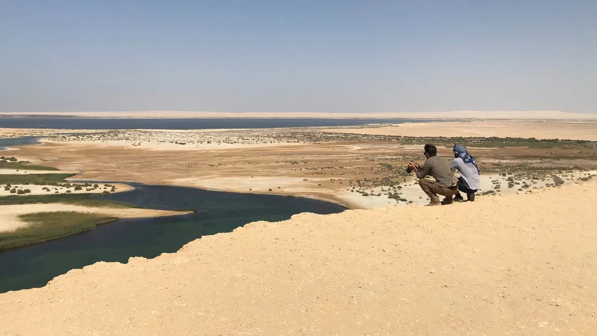 Walkers overlooking a desert lake, Egypt — Nicolas Marincic