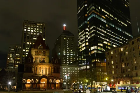 Trinity Church lit at night below the Copley towers, Boston, United States — Nicolas Marincic