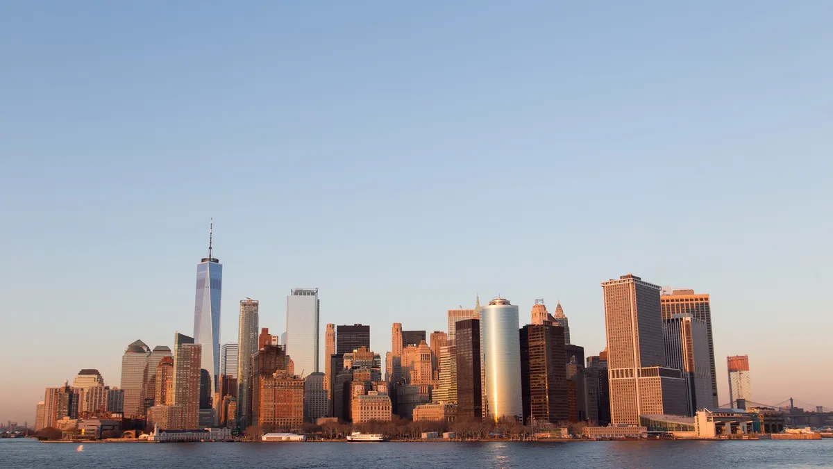 Lower Manhattan glowing at sunset from the harbour, United States — Nicolas Marincic
