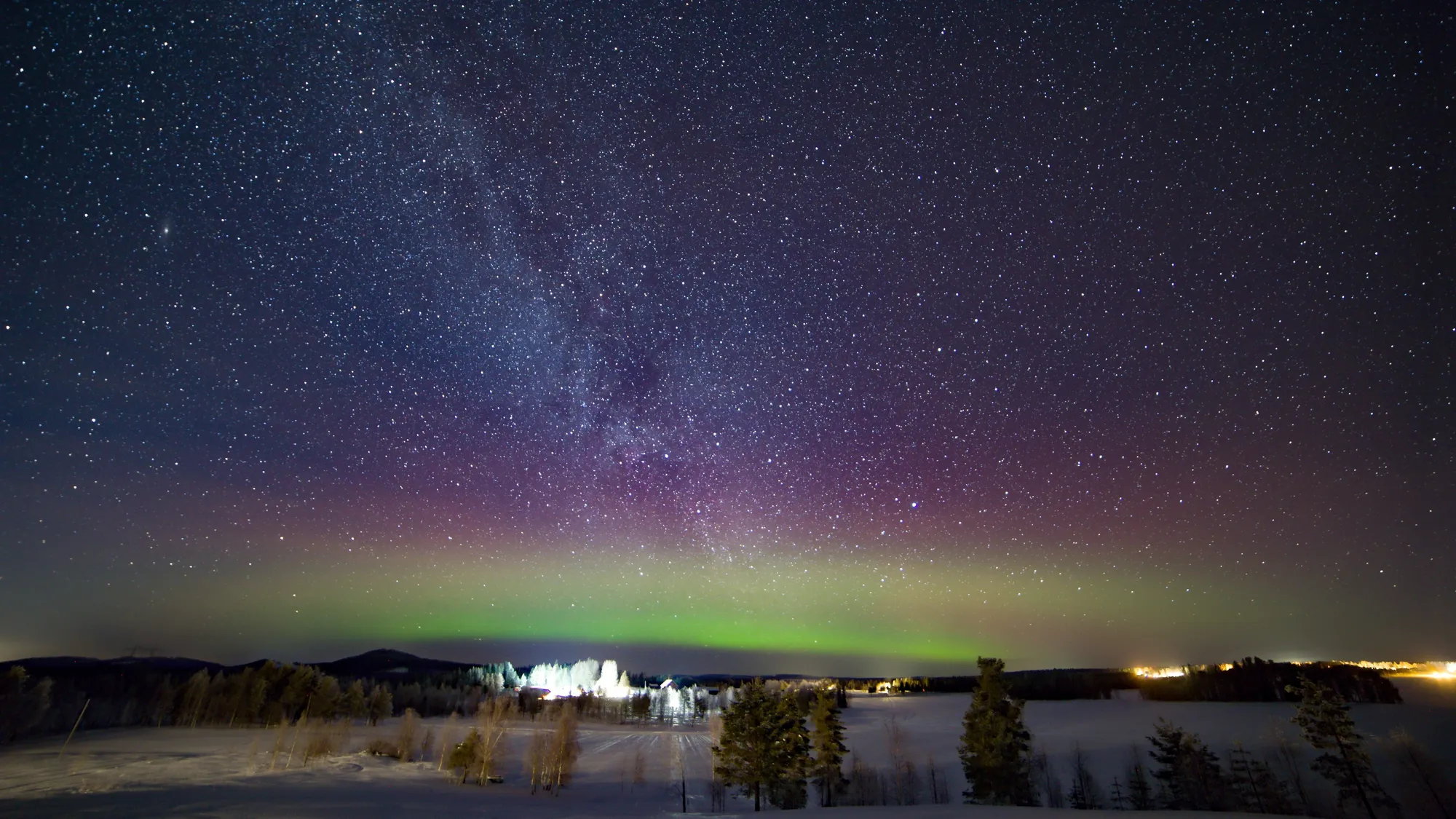 Aurora borealis beneath the Milky Way over a snowy lake, Sweden — Nicolas Marincic