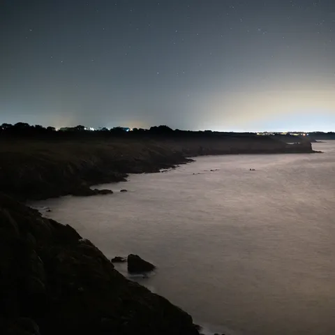 Rocky coast under a starry sky, France — Nicolas Marincic