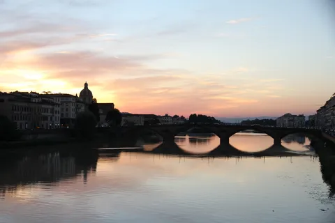 Ponte Santa Trinita silhouetted on the Arno at sunset, Italy — Nicolas Marincic