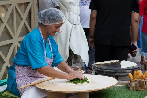 Woman preparing a herb flatbread, Georgia — Nicolas Marincic