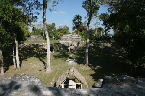 Group E and stelae under thatched shelters, Uaxactún, Guatemala — Nicolas Marincic