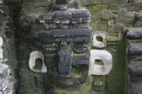 Stucco mask on the North Acropolis, Tikal, Guatemala — Nicolas Marincic