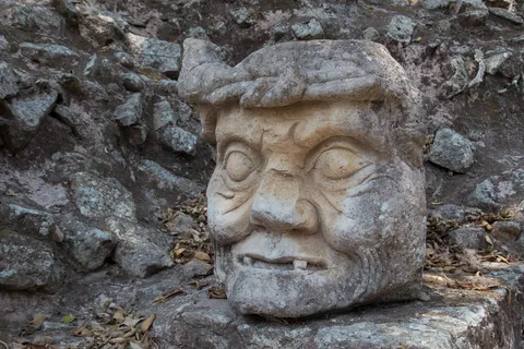 Carved head, possibly Pawahtun, Copán, Honduras — Nicolas Marincic