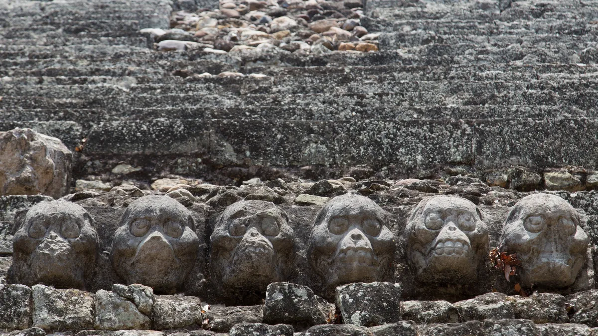 Row of carved skulls, Copán, Honduras — Nicolas Marincic