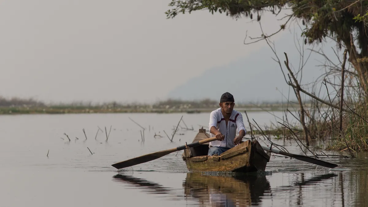 Fisherman in a dugout on a lake, Honduras — Nicolas Marincic