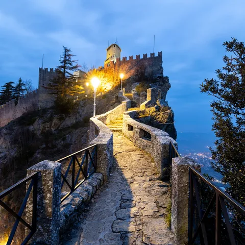 Lamplit path to the Guaita at blue hour, San Marino — Nicolas Marincic