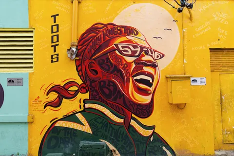 Toots Hibbert mural on a yellow wall, Kingston, Jamaica — Nicolas Marincic