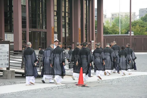 Monks walking in procession past a temple, Japan — Nicolas Marincic