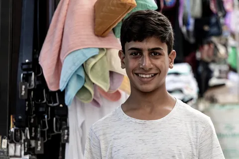 Smiling young vendor in the souk of Salt, Jordan — Nicolas Marincic