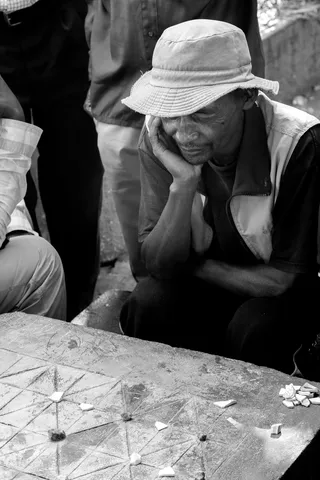 Fanorona player deep in thought, Madagascar — Nicolas Marincic