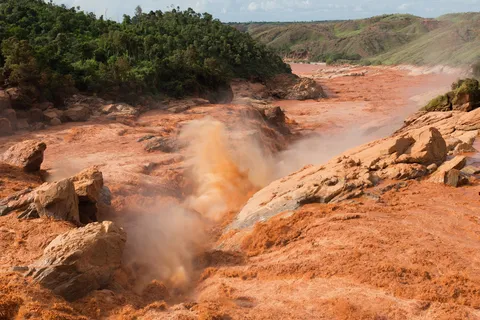 Waterfall running red with laterite, Madagascar — Nicolas Marincic