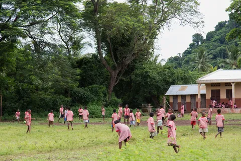 Schoolchildren in pink smocks at break time, Madagascar — Nicolas Marincic