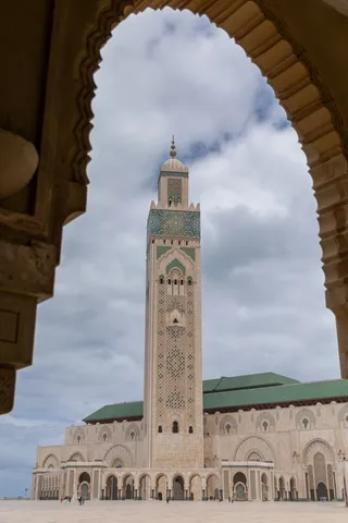 Hassan II Mosque minaret framed by a carved arch, Morocco — Nicolas Marincic
