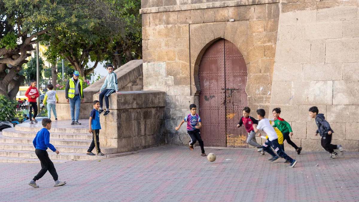 Street football by a medina gate, Morocco — Nicolas Marincic