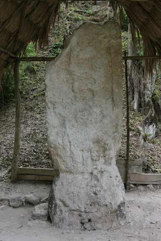 Maya stela under a palm-thatched roof, Guatemala — Nicolas Marincic