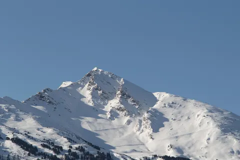 Snowy peak under a blue sky, France — Nicolas Marincic