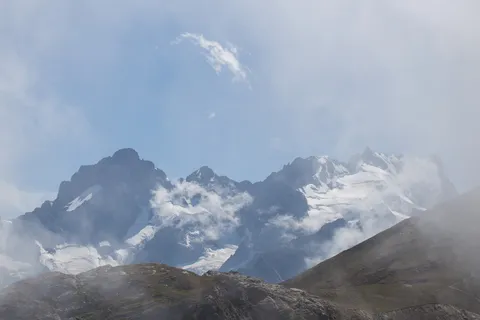Glaciated peaks rising from the clouds, France — Nicolas Marincic