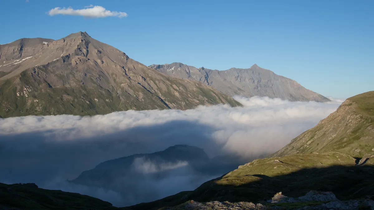 Sea of clouds below sunlit summits, Mont-Cenis, France — Nicolas Marincic
